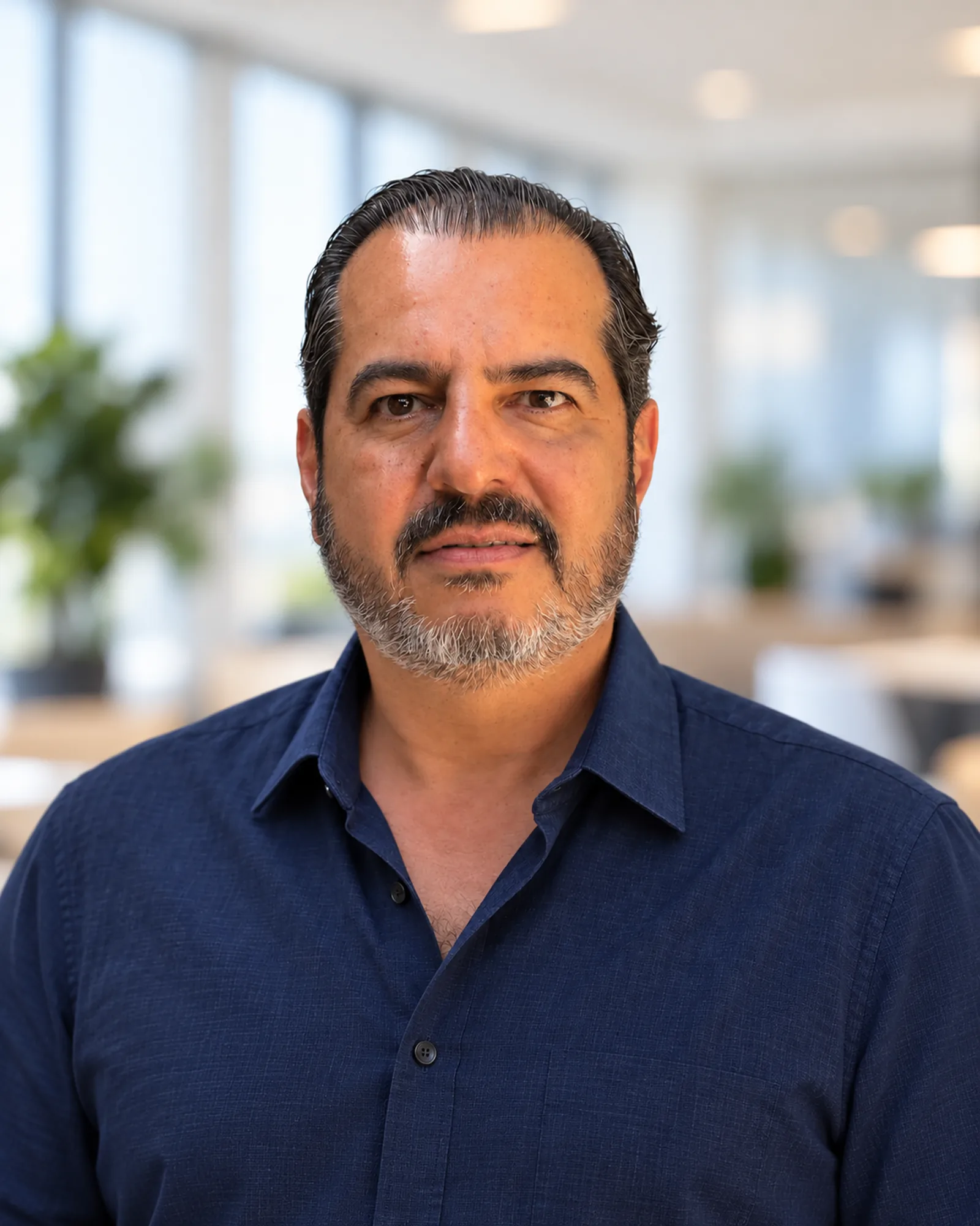 Carlos Molina, founder of Embedding Labs, against a softly blurred office background.