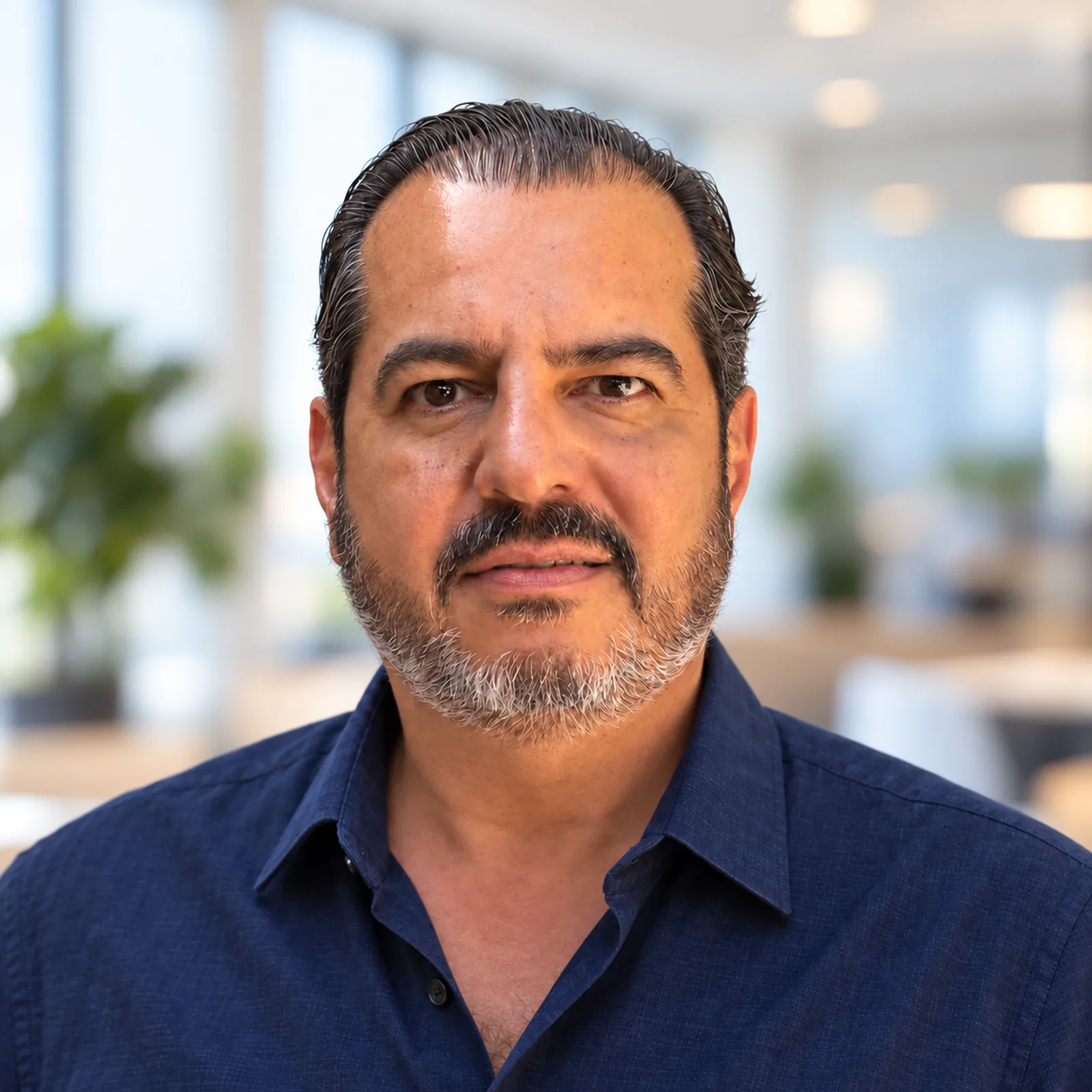 Carlos Molina, founder of Embedding Labs, against a softly blurred office background.